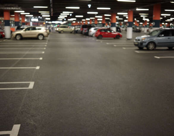 Horizontal picture of car parking or underground garage interior with neon lights and autocars parked. Buildings, urban constructions, space, transportation, vehicle and night city concept Horizontal picture of car parking or underground garage interior with neon lights and autocars parked. Buildings, urban constructions, space, transportation, vehicle and night city concept