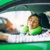 Woman sleeping in car on pillow and driving with her husband Woman sleeping in car on pillow and driving with her husband